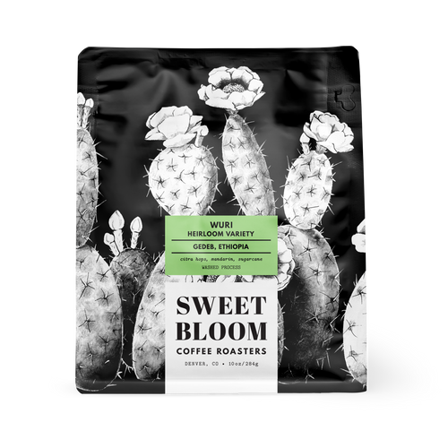 A 10 oz bag of Sweet Bloom Coffee Roasters 'Wuri' Heirloom Variety coffee from Gedeo, Ethiopia. The packaging is a matte black stand-up pouch decorated with a high-contrast black and white cactus illustration, featuring a green and white label in the center.